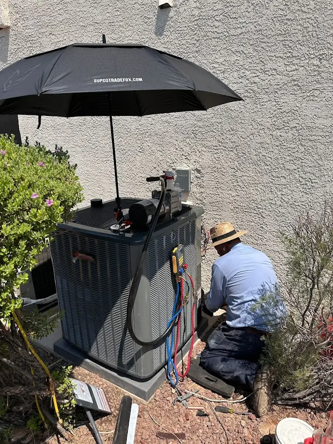 HVAC technician performing outdoor AC maintenance in Butner
